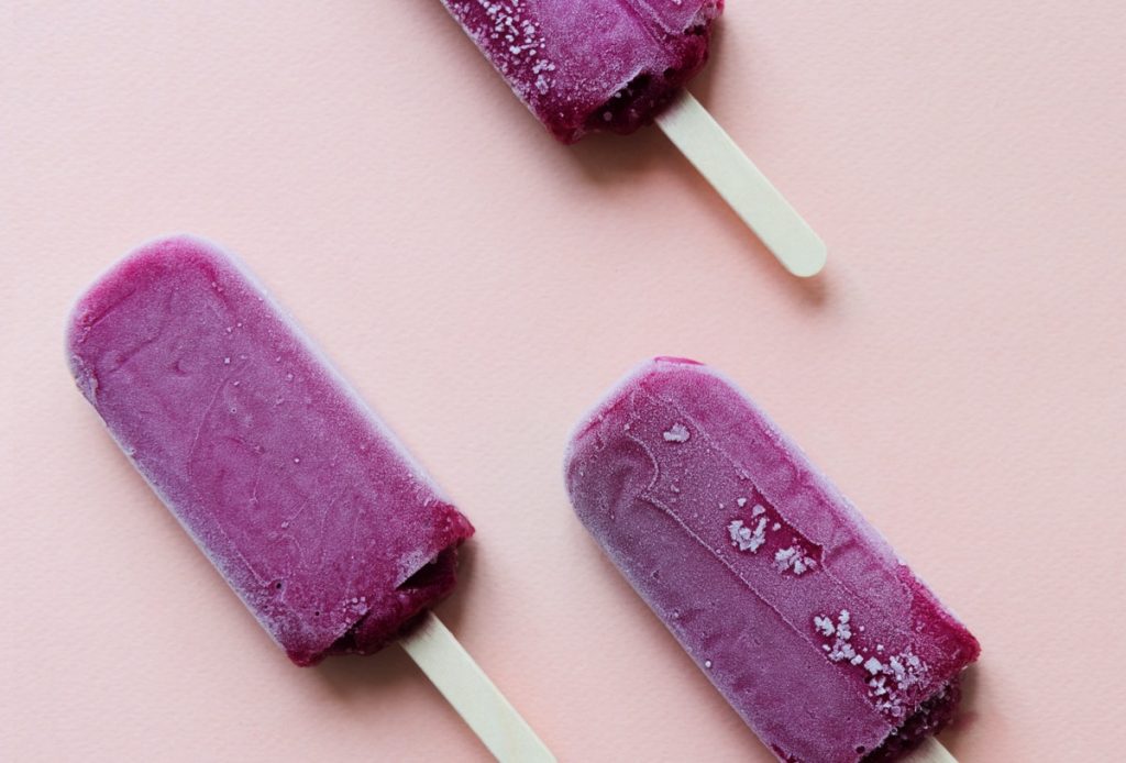 purple popsicles on pink background