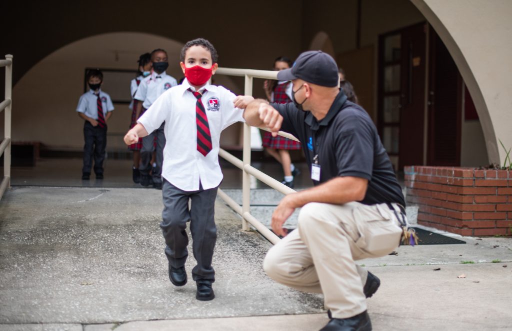 child returning an elbow bump