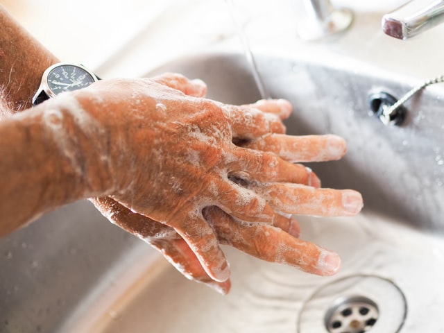 washing hands in kitchen sink