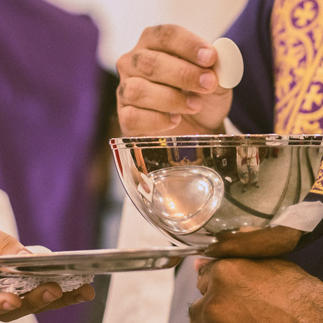 priest serving Communion